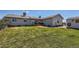 Well-manicured backyard featuring a spacious lawn, deck, and storage shed perfect for outdoor living at 7716 Shenandoah Dr, Elizabeth, CO 80107