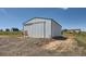 Large barn with sliding door, a swing and a gravel lot, perfect for storage or hobbies at 7716 Shenandoah Dr, Elizabeth, CO 80107