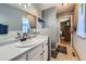 Bathroom with modern fixtures, white vanity, and a view of the bedroom through an open doorway at 7716 Shenandoah Dr, Elizabeth, CO 80107