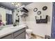 Bathroom with modern light fixtures, a decorative mirror, and stylish towel holders at 7716 Shenandoah Dr, Elizabeth, CO 80107