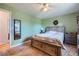 Bedroom with neutral green paint, wood bed, earth-tone carpet, and a view to the outside at 7716 Shenandoah Dr, Elizabeth, CO 80107