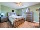 Well-lit bedroom with earth-tone paint, large wood bed and dresser, and ample natural light at 7716 Shenandoah Dr, Elizabeth, CO 80107