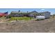 Exterior view of the home with a large yard, storage tank, American flag, and gravel ground cover at 7716 Shenandoah Dr, Elizabeth, CO 80107
