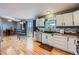 Spacious kitchen with white cabinets, stainless steel appliances, and an adjacent dining area at 7716 Shenandoah Dr, Elizabeth, CO 80107