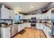 Bright kitchen featuring white cabinets, stainless steel appliances, and sleek countertops at 7716 Shenandoah Dr, Elizabeth, CO 80107
