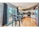 Open concept kitchen with white cabinets and eat in dining area with access to outdoor deck at 7716 Shenandoah Dr, Elizabeth, CO 80107
