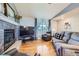 Comfortable living room with hardwood floors, a fireplace, and a large TV for relaxing evenings at 7716 Shenandoah Dr, Elizabeth, CO 80107