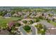 Aerial view of a luxury home with a circular driveway surrounded by a lush, green neighborhood at 2378 Plumb Pl, Erie, CO 80516