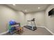 Basement gym area featuring a treadmill, yoga mat and weight rack, ideal for fitness enthusiasts at 2378 Plumb Pl, Erie, CO 80516