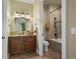 Well-lit bathroom featuring a wooden vanity with granite countertops and a separate shower area at 2378 Plumb Pl, Erie, CO 80516