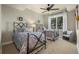 Bright bedroom with two twin beds, a ceiling fan, and a window providing natural light at 2378 Plumb Pl, Erie, CO 80516