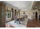 Elegant dining room with hardwood floors, large windows, and a sophisticated chandelier at 2378 Plumb Pl, Erie, CO 80516