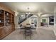 Spacious dining room with a large wooden bookcase, chandelier, and access to other living areas at 2378 Plumb Pl, Erie, CO 80516
