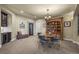 Inviting dining area with a round table, ornate chandelier, and custom shelving at 2378 Plumb Pl, Erie, CO 80516
