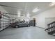 Spacious three car garage with epoxy floors, storage and an EV charger, perfect for car enthusiasts at 2378 Plumb Pl, Erie, CO 80516