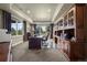 Spacious home office with custom built-ins, a large desk, and plenty of natural light at 2378 Plumb Pl, Erie, CO 80516