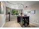 Well-lit home office with modern desk and ample natural light, perfect for remote work at 2378 Plumb Pl, Erie, CO 80516