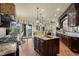 Modern kitchen featuring a center island, stainless steel appliances, and access to the outdoor patio at 2378 Plumb Pl, Erie, CO 80516