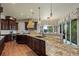 Gourmet kitchen with a large island, custom cabinetry, and a view to the outdoor entertaining area at 2378 Plumb Pl, Erie, CO 80516