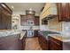 Beautiful kitchen with granite countertops, stainless steel appliances, and custom cabinetry at 2378 Plumb Pl, Erie, CO 80516