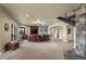 Comfortable living room with a stone fireplace, leather seating, and access to the outdoors at 2378 Plumb Pl, Erie, CO 80516