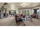 Open-concept living room with a bar, leather furniture, and multiple seating areas at 2378 Plumb Pl, Erie, CO 80516