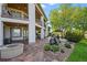 Spacious covered patio with outdoor seating and stairs to the upper balcony overlooking the lawn and landscaping at 2378 Plumb Pl, Erie, CO 80516
