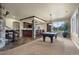 Entertainment room with custom bar, pool table, and natural light, perfect for relaxing and socializing at 2378 Plumb Pl, Erie, CO 80516