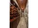 Impressive wine cellar with stone walls, wooden racks, and ample storage for wine collections at 2378 Plumb Pl, Erie, CO 80516