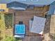 Aerial shot showing hot tub and a covered outdoor seating area with umbrella on the home's deck at 6979 Weasel Way, Evergreen, CO 80439