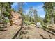 Outdoor backyard recreational area with climbing wall and seating at 6979 Weasel Way, Evergreen, CO 80439