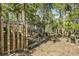Wood storage is fenced off in the wooded backyard at 6979 Weasel Way, Evergreen, CO 80439