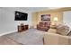 Inviting basement area with comfortable seating, TV, and laminate flooring at 6979 Weasel Way, Evergreen, CO 80439