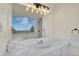 Bright bathroom with vanity, sink, mirror and scenic view from the window at 6979 Weasel Way, Evergreen, CO 80439