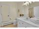 Bright bathroom features a white vanity with modern lighting and neutral wall color at 6979 Weasel Way, Evergreen, CO 80439