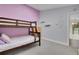 Bedroom with light grey and light purple walls, carpet, bunk beds, and wood dresser at 6979 Weasel Way, Evergreen, CO 80439