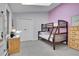 Bedroom with skylight, light grey walls, carpet, bunk beds, and wood dresser at 6979 Weasel Way, Evergreen, CO 80439