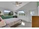 Cozy bedroom with scenic mountain views from large windows and vaulted ceiling at 6979 Weasel Way, Evergreen, CO 80439