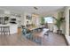 Elegant dining area with modern lighting and natural wood furniture, adjacent to kitchen at 6979 Weasel Way, Evergreen, CO 80439