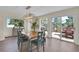 Elegant dining room with hardwood floors, bright windows, and sliding door to deck at 6979 Weasel Way, Evergreen, CO 80439