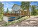 Charming two-story home featuring a spacious deck, garage, and kayaks, nestled in a natural setting at 6979 Weasel Way, Evergreen, CO 80439