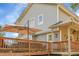 Close up view of home featuring spacious deck with wooden railings and outdoor umbrella at 6979 Weasel Way, Evergreen, CO 80439
