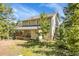 Charming two-story home with a wrap-around deck, nestled in a natural setting with mature trees at 6979 Weasel Way, Evergreen, CO 80439