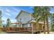 Stunning two-story house featuring a large deck perfect for outdoor entertaining at 6979 Weasel Way, Evergreen, CO 80439