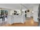 Open-concept kitchen with island flows seamlessly into dining and living areas at 6979 Weasel Way, Evergreen, CO 80439