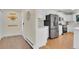 Well-lit kitchen featuring modern appliances, ample counter space, and an adjacent entryway at 6979 Weasel Way, Evergreen, CO 80439