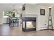 Modern fireplace with hardwood flooring adjacent to dining area at 6979 Weasel Way, Evergreen, CO 80439