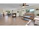 Spacious living room featuring modern fireplace, hardwood floors, and natural light with mountain views at 6979 Weasel Way, Evergreen, CO 80439
