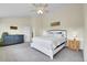 Bright main bedroom with a ceiling fan, neutral carpet, and comfortable furniture at 6979 Weasel Way, Evergreen, CO 80439