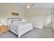 Bright bedroom with a ceiling fan, carpeted floors, and neutral color scheme at 6979 Weasel Way, Evergreen, CO 80439